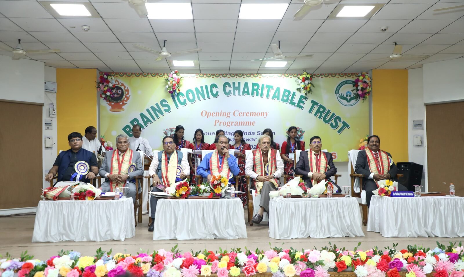 Dignitaries seated on stage at the Brains Iconic Charitable Trust Opening Ceremony Programme.