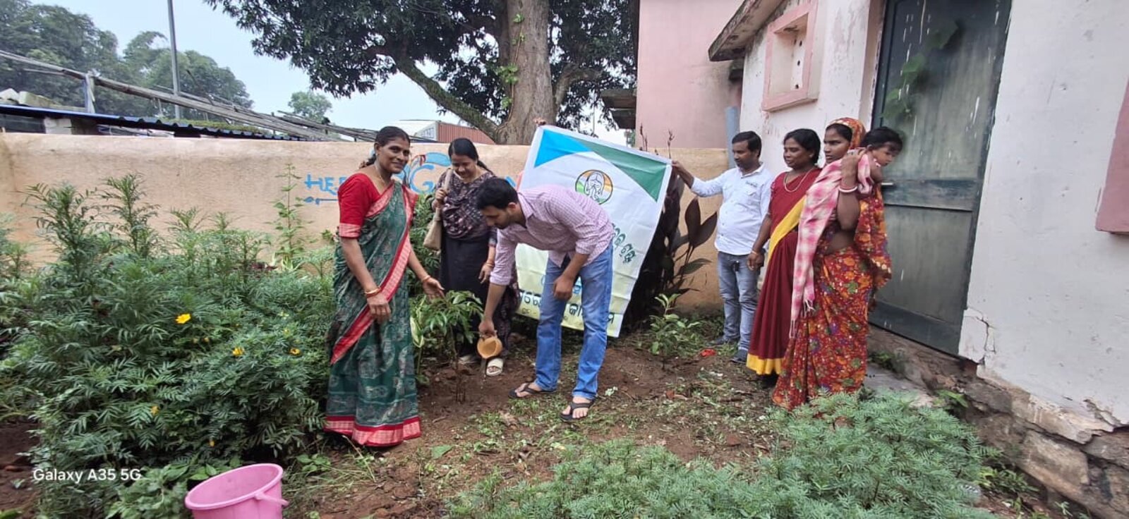 Volunteers watering a newly-planted sapling during a Brains Iconic Charitable Trust plantation drive.